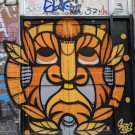 Mural of some sort of orange deity or creature on a pair of doors